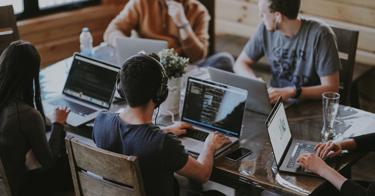 DTC brand in-house marketing team working with AI tools at a modern workspace